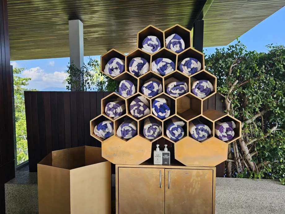 Håndklær og solkrem ved bassenget